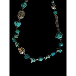 Beautiful long natural turquoise and silver toned necklace.